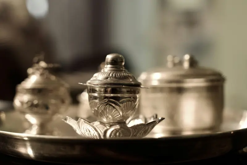 Silver teapot on a butler tray