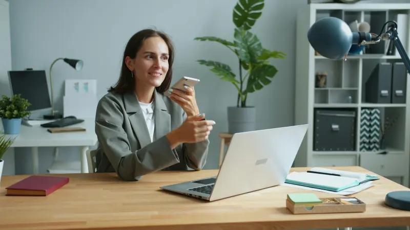 Taking a phone call at a desk at home