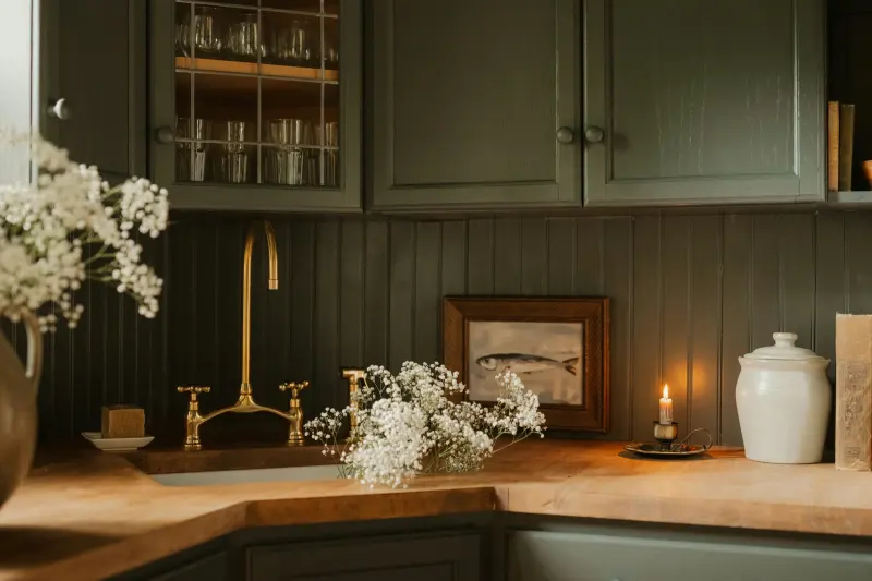 Finished country kitchen: green shaker cabinets, brass taps, oak worktop
